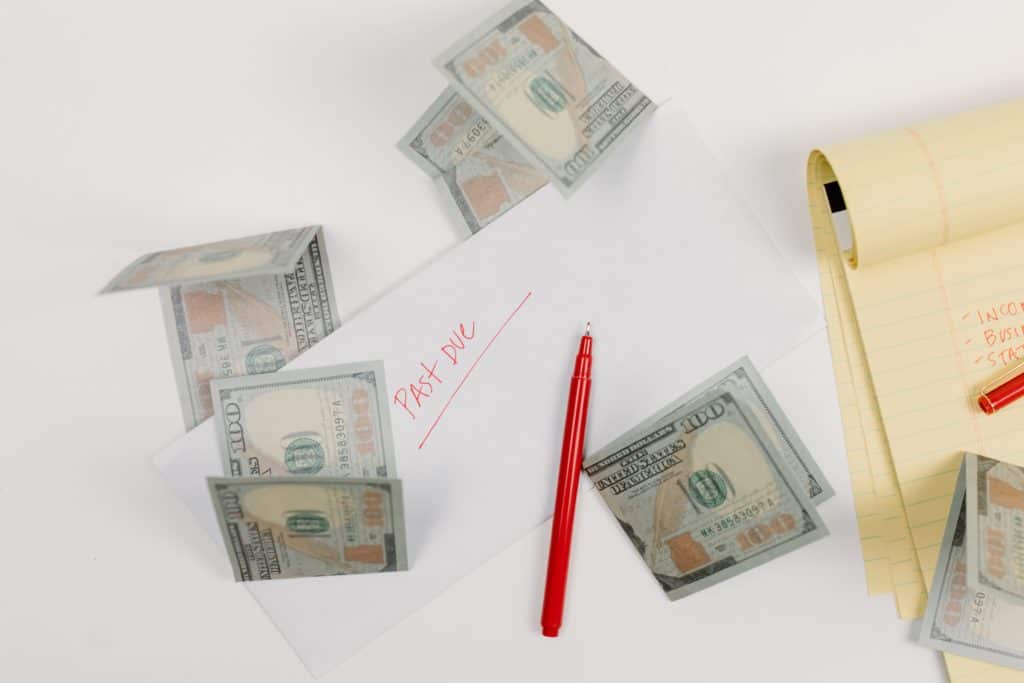 Papers and money laying on a table. These people could benefit from QuickBooks