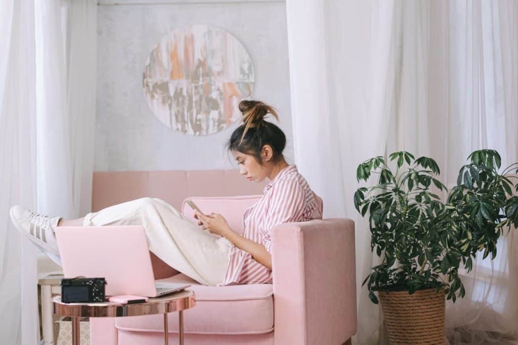 A person sitting on a couch possibly working in a hybrid work mode
