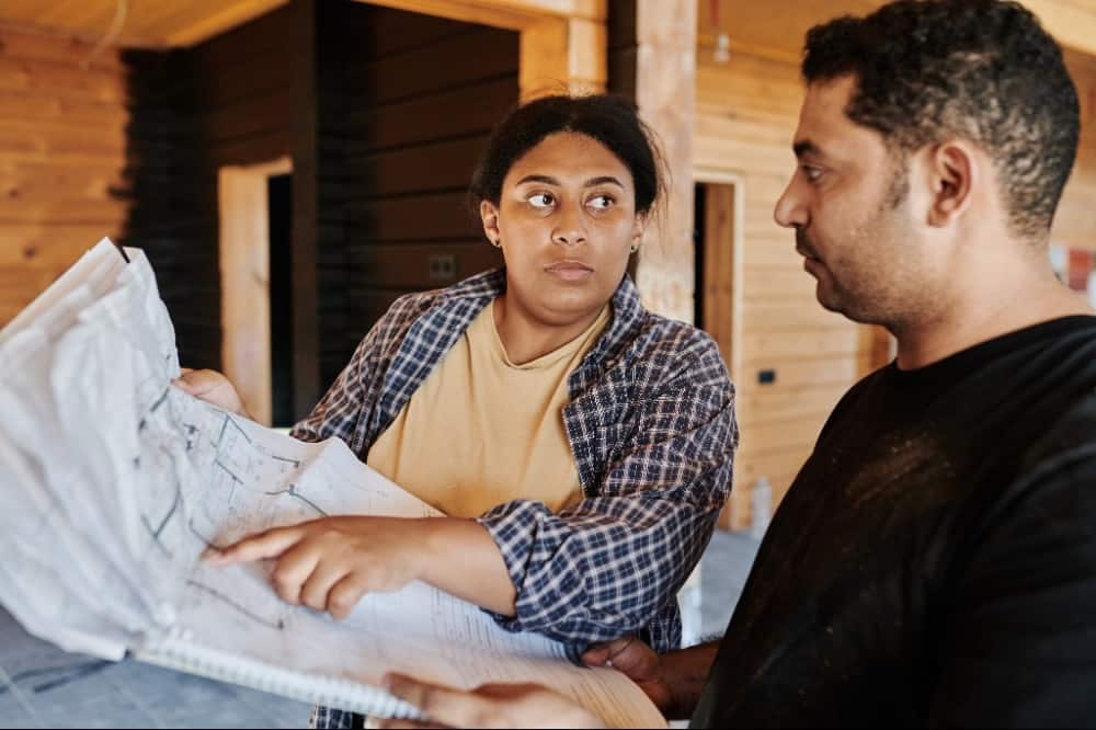 two people looking at a blueprint