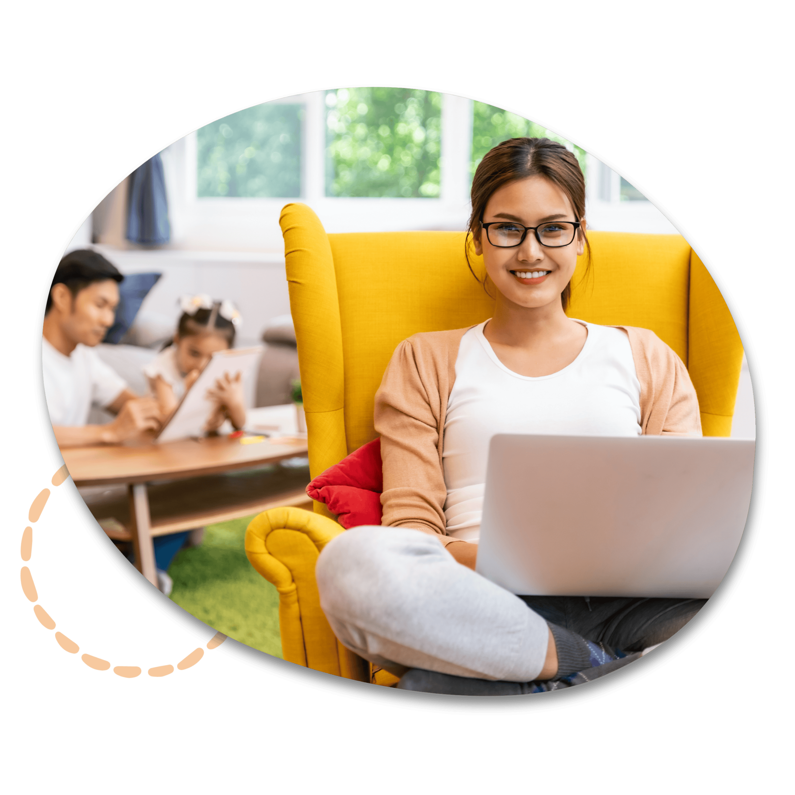Achieve Your Professional Goals Image - A woman with a laptop smiling. Her husband and child can be seen in the background.